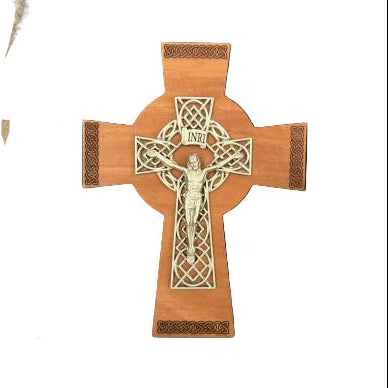 Wooden cross with intricate carvings on a white background