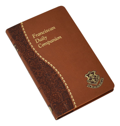 Franciscan Daily Companion book with brown cover, gold lettering, ornate side pattern, and emblem on front lower corner