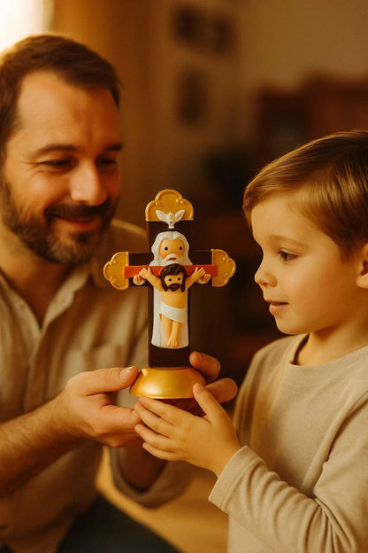 Holy Trinity Cross figurine with Father, Son, and Holy Spirit held by smiling man and child in warm room setting