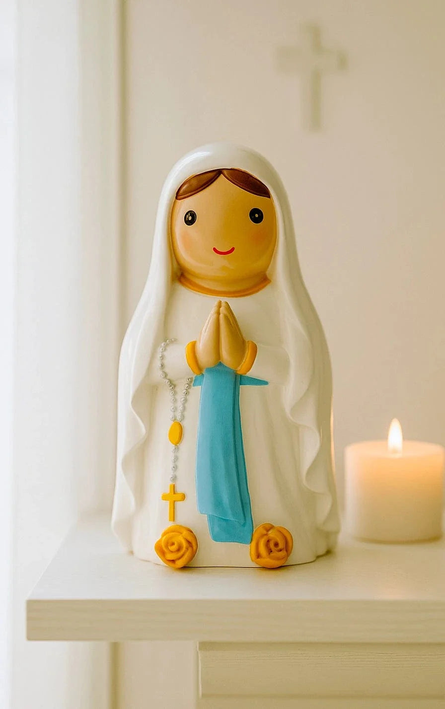 3.5" Our Lady of Lourdes collector’s edition figurine with blue sash, praying hands, and yellow rosary beads on shelf